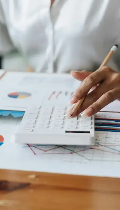 close-up-accountant-banker-or-bookkeeper-making-calculation-with-calculator